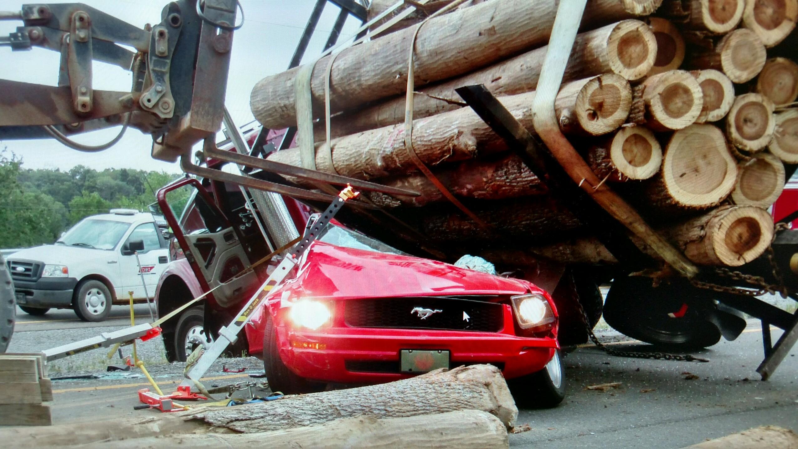 Woman Survives Crash With Logging Truck 